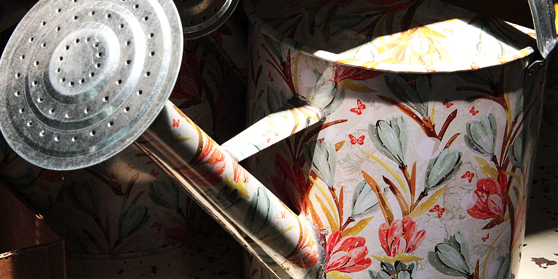 decorated metal watering can